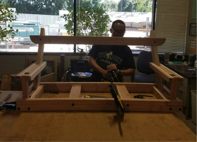 Engineering intern Paul Casabag working on a DIY porch swing project. 