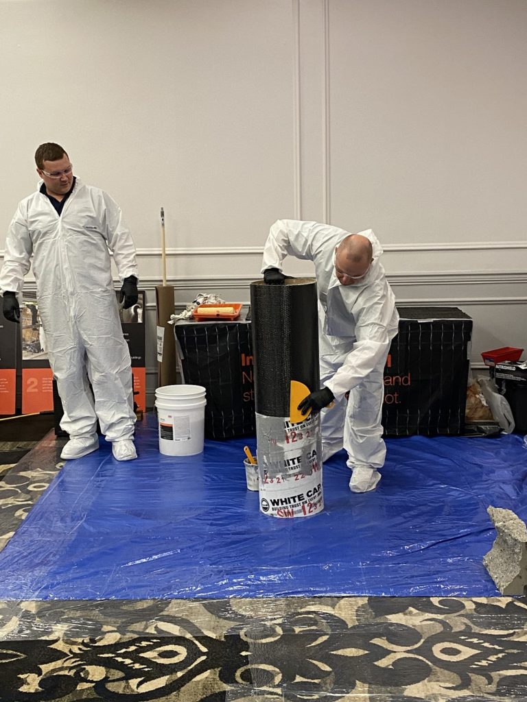 Rick Bagby installing the wet-layup column wrap.