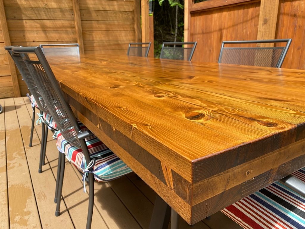 Up close of Mass Timber Table with black powder coated legs