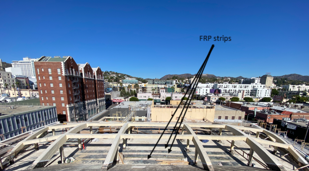 Photo 2: Trusses and beams (not seen) support the theater’s roof structure. Note that FRP strips are used to provide a lightweight diaphragm-strengthening solution.