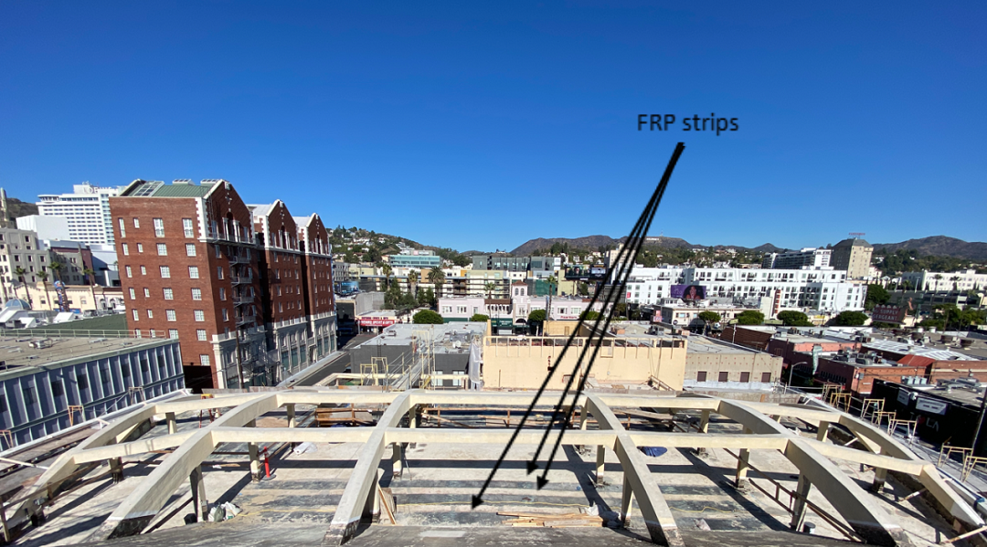Photo 2: Trusses and beams (not seen) support the theater’s roof structure. Note that FRP strips are used to provide a lightweight diaphragm-strengthening solution. 