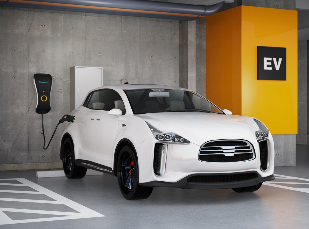 White electric SUV recharging in parking garage.